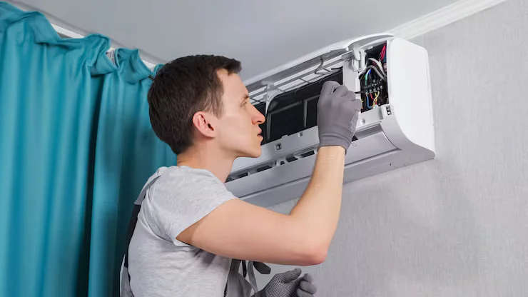 Technician repair aircond on wall