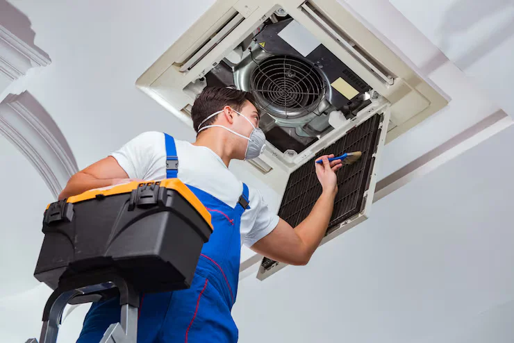 technician repairing commercial aircond